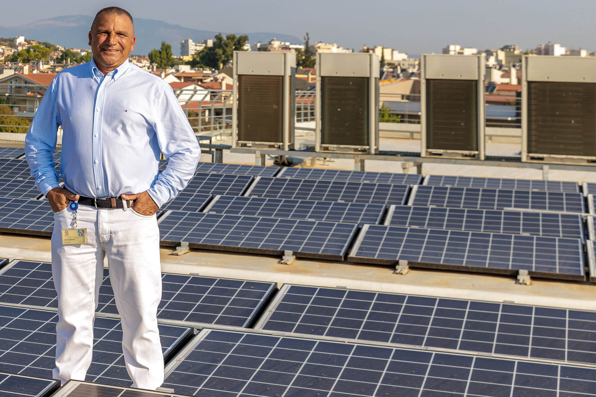 a man standing in between lots of solar panels