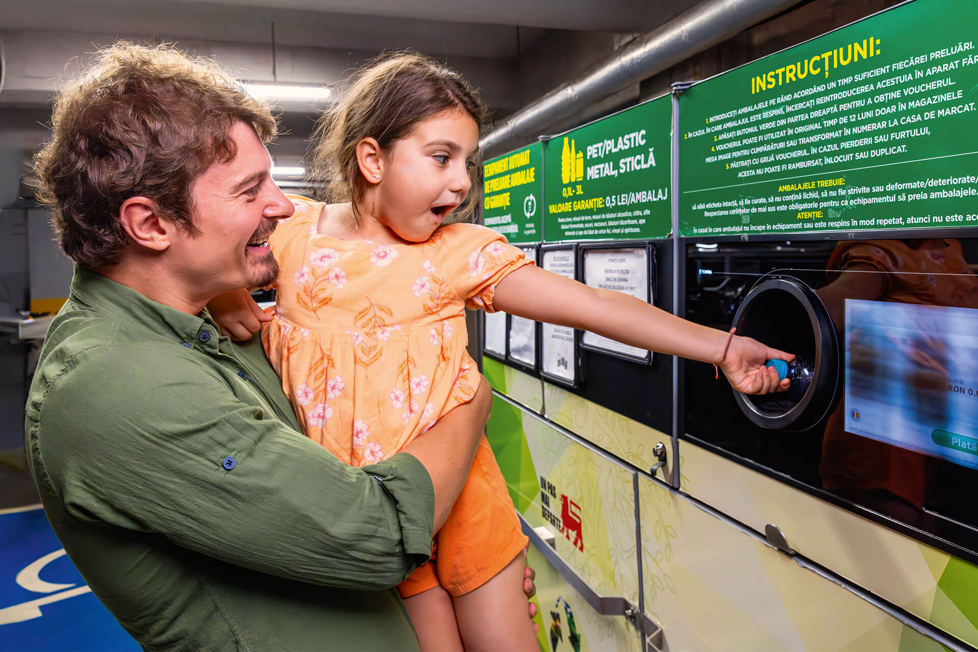 A man holding a young girl pointing at a screen