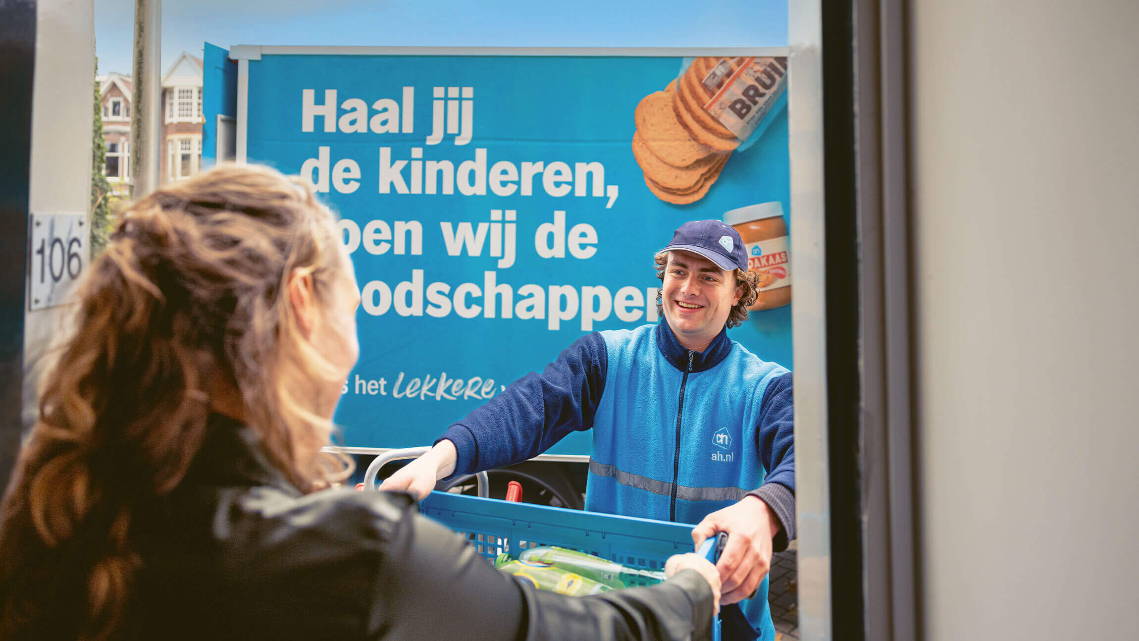 Someone collecting their supermarket delivery at their front door