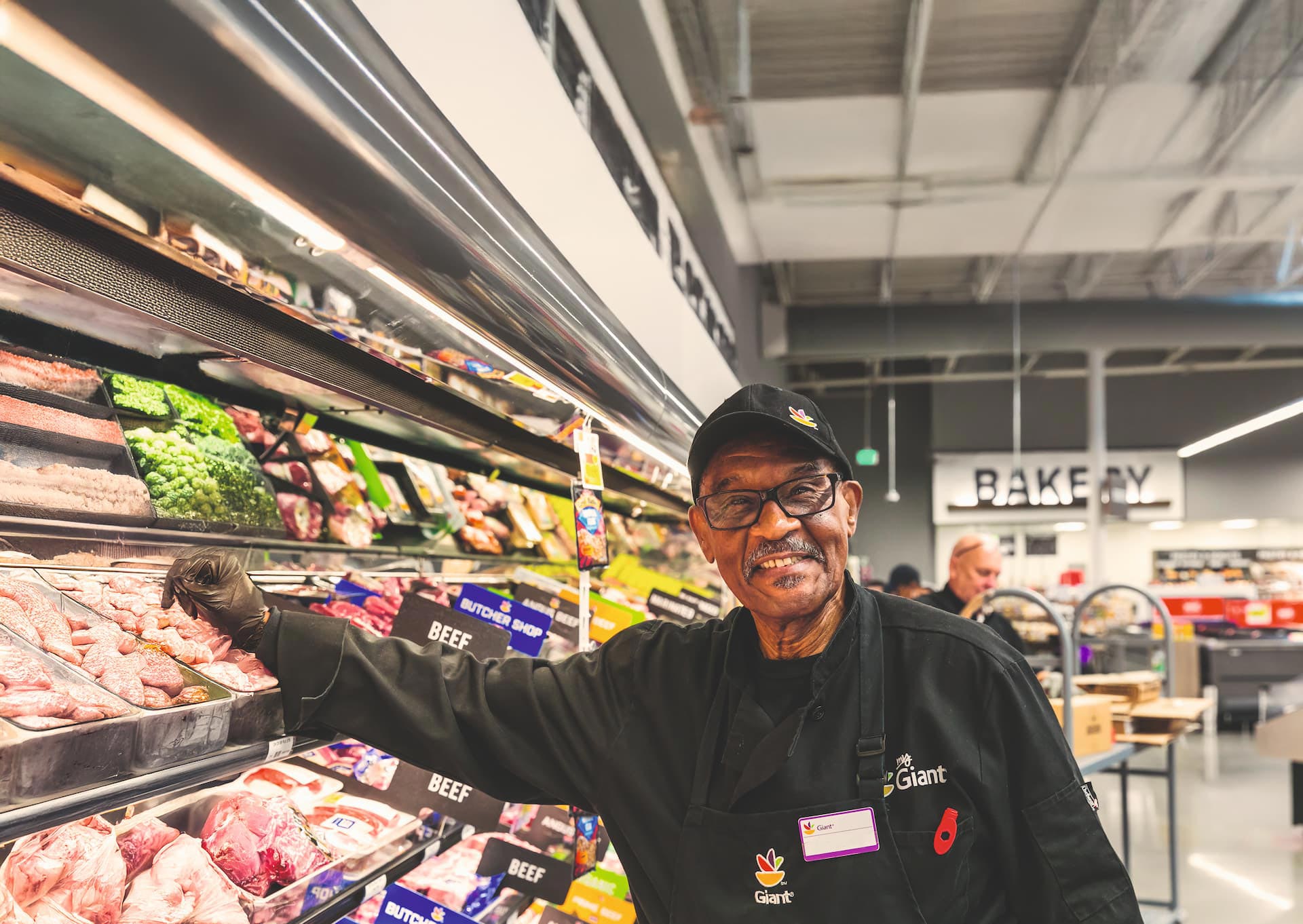 a happy male employee in a supermarket smiling at the camera