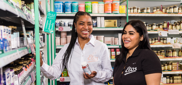 a photo of two people interacting in a supermarket